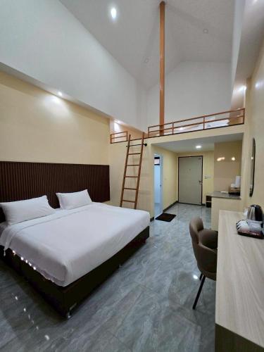 a bedroom with a bed with a ladder and a staircase at The Y Habitat in Kanchanaburi City