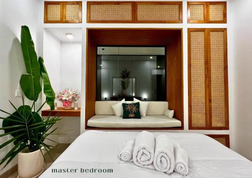 a bedroom with a bed with towels on it at Surya Palm Villa in Tumbak Bayuh