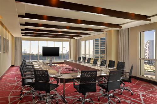 a large conference room with a long table and chairs at Radisson Blu Hotel, Dubai Barsha Heights in Dubai
