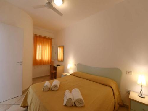 a bedroom with a bed with white towels on it at Studio for couples in Capo Vaticano with pool in Capo Vaticano
