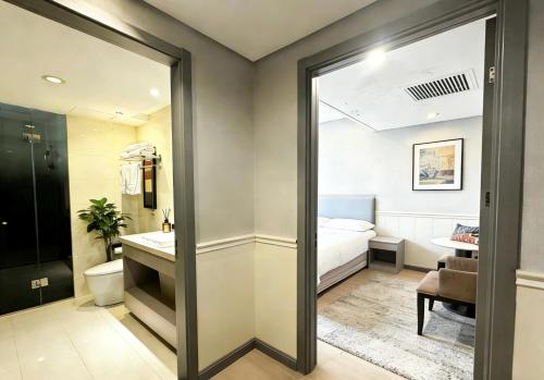 a bathroom with a bed and a toilet and a sink at Yiwu Bai Heng Hotel in Yiwu
