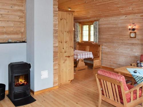a living room with a fireplace in a log cabin at 4 person holiday home in olden in Olden