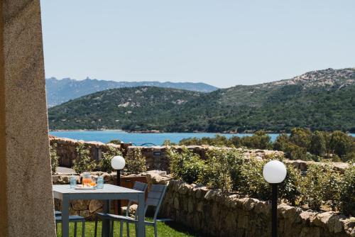 a table and chairs with a view of a lake at Le Ville Le Saline in Palau