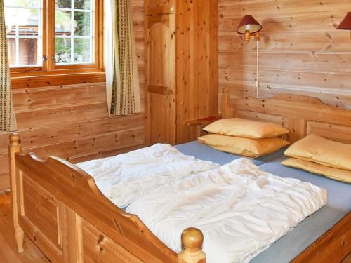 a bedroom with two beds in a log cabin at 5 person holiday home in olden in Olden