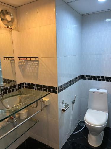 a bathroom with a toilet and a sink at Home at the Gulf of Thailand 1 in Ban Pak Khlong Phe