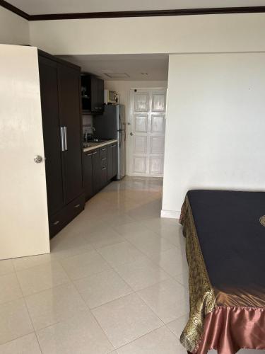 a large room with a kitchen and a bed in it at Home at the Gulf of Thailand 1 in Ban Pak Khlong Phe