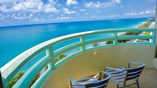 two chairs sitting on a balcony overlooking the ocean at Home at the Gulf of Thailand 1 in Ban Pak Khlong Phe