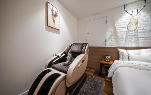 a hotel room with a chair next to a bed at MARI hotel in Incheon