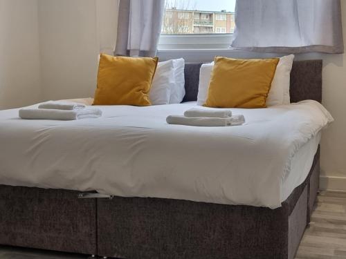 a large bed with two towels on top of it at Away Home in London