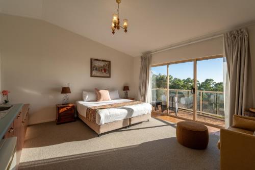 a bedroom with a bed and a large window at Eagle Heights Mountain Resort in Eagle Heights