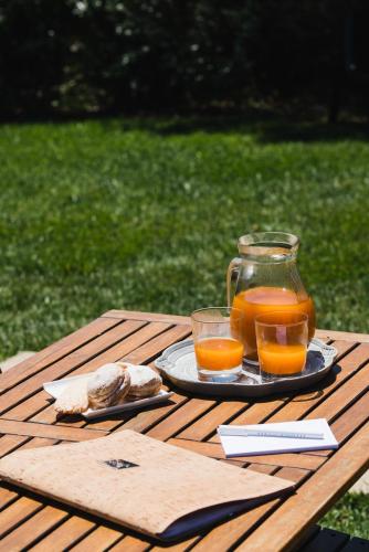 a jug of juice and two glasses on a picnic table at Le Ville Le Saline in Palau