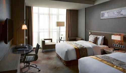 En eller flere senge i et værelse på Meliá Jinan