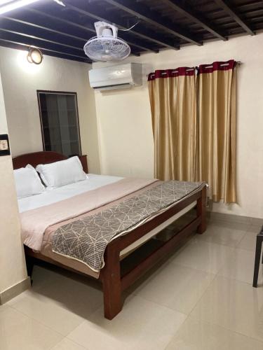 a bedroom with a large bed with a blue ceiling at Kakkakuni heritage in Kozhikode