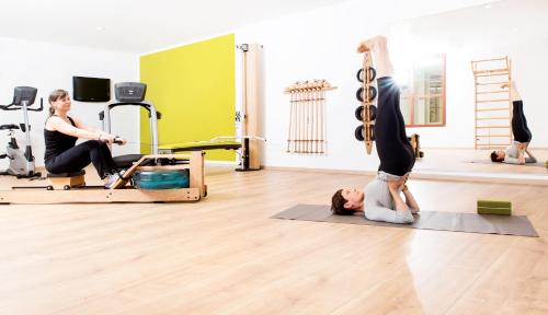 two women in a pilates class in a gym at Ringhotel Teutoburger Wald in Tecklenburg