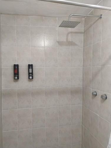 a bathroom with a shower with two lights on it at Casa centrica in Hermosillo