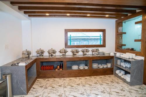 a kitchen with a counter with dishes on it at Hotel grandlords in Pahalgām