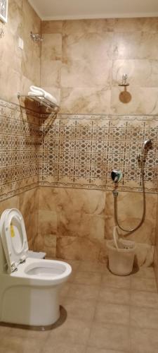 a bathroom with a toilet and a shower at La Sea Vue Goa in Goa