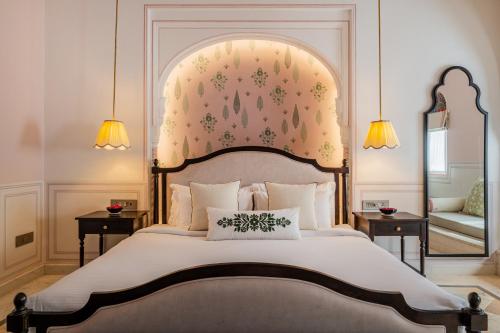 a bedroom with a large bed with a large headboard at Padmaa Jaipur in Jaipur