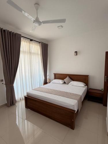 a bedroom with a large bed and a ceiling fan at 2BR luxury Apartment in Mount Lavinia - Benetia Stay in Mount Lavinia