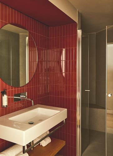 a bathroom with a white sink and a mirror at Rifugio Colere 1600 by Cloud 7 in Colere