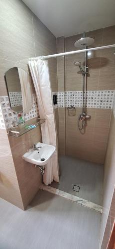 a bathroom with a shower and a sink at Coba Inn Alona Panglao in Panglao Island
