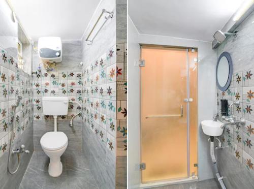a bathroom with a shower and a toilet at Hotel Rose Inn in Kolkata