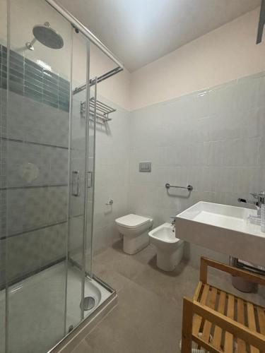 a bathroom with a shower and a toilet and a sink at ModicAlta in Modica