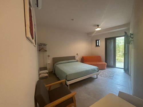 a bedroom with a bed and a chair in it at ModicAlta in Modica