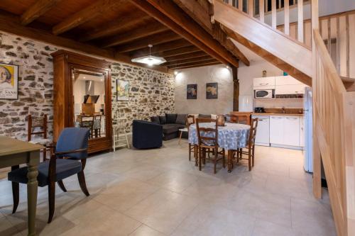 a kitchen and a dining room with a table and chairs at Gîte Léon - Au cœur du village 4 pers in Gargilesse-Dampierre