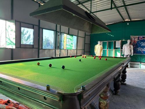 a pool table with balls on it in a room at Gauri Homestay in Pithorāgarh
