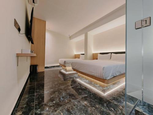 a bedroom with a bed and a glass wall at Hotel Classic in Malacca