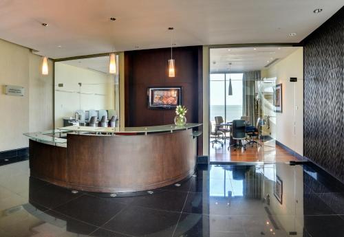 a lobby with a reception desk in a building at Sofitel Al Khobar The Corniche in Al Khobar