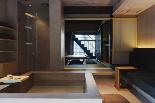 a living room with a couch and a table at MUDANI 達磨町 Darumacho in Kyoto