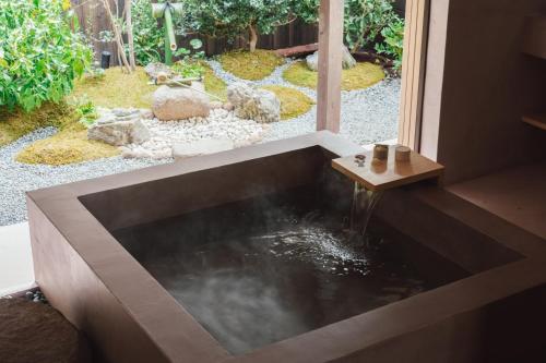 a koi pond in a house with a garden at MUDANI 達磨町 Darumacho in Kyoto
