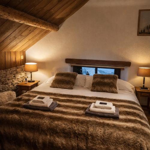a bedroom with a large bed with towels on it at B&B Ferme1883 in Lierneux