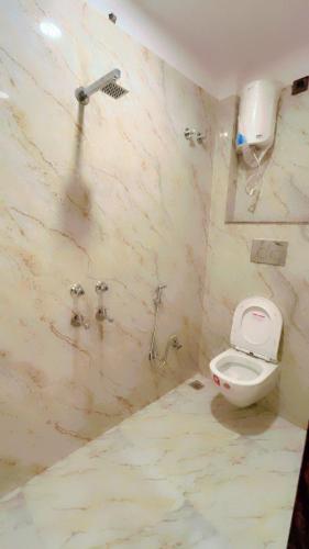 a bathroom with a toilet and a shower at SOALTEE Near Lucknow Airport in Lucknow