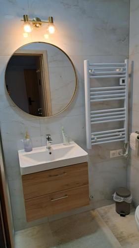 a bathroom with a sink and a mirror at Sobe Magnolija, self check-in in Vinkovci