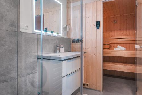 a bathroom with a sink and a shower at Lütt Mööv - Seestraße 8 4 in Kellenhusen