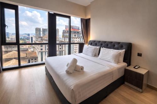 a bedroom with a bed with a stuffed animal on it at klcc Star residence Kuala Lumpur in Kuala Lumpur