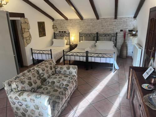 a living room with two beds and a couch at Osteria del Cavaliere B&B e Maneggio in Sacrofano