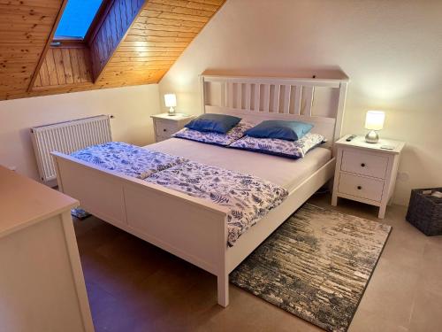 a bedroom with a large bed and two night stands at Dům pod horami - Beskydy in Frýdlant nad Ostravicí