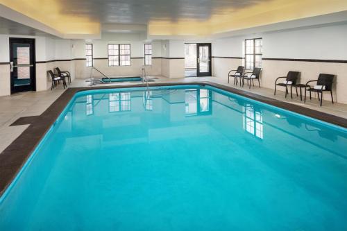 a large pool with blue water in a building at Homewood Suites by Hilton Denver International Airport in Denver