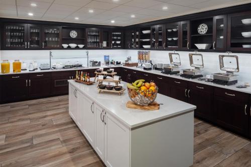 a kitchen with a counter with a bowl of fruit on it at Homewood Suites by Hilton Denver International Airport in Denver