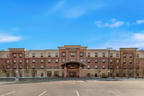 an empty parking lot in front of a large brick building at Hampton Inn & Suites Detroit-Canton in Canton