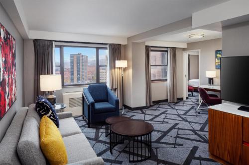 a living room with a couch and a chair at DoubleTree by Hilton Hotel & Suites Pittsburgh Downtown in Pittsburgh
