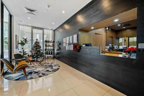 a living room with a christmas tree on the floor at The Kingsford, an Ascend Collection Hotel in Brisbane