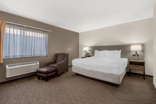 a hotel room with a bed and a chair at Comfort Inn Cockatoo Near LAX Airport in Hawthorne