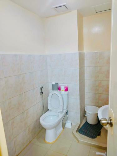 a bathroom with a toilet and a sink at Seawind in Davao City