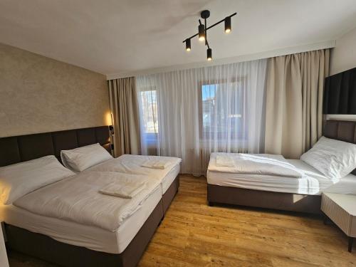 a bedroom with two beds and a window at Balónový hotel a pivovar Radešín in Radešín