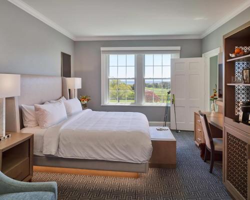 a bedroom with a bed and a desk and a window at Seaview Hotel in Galloway